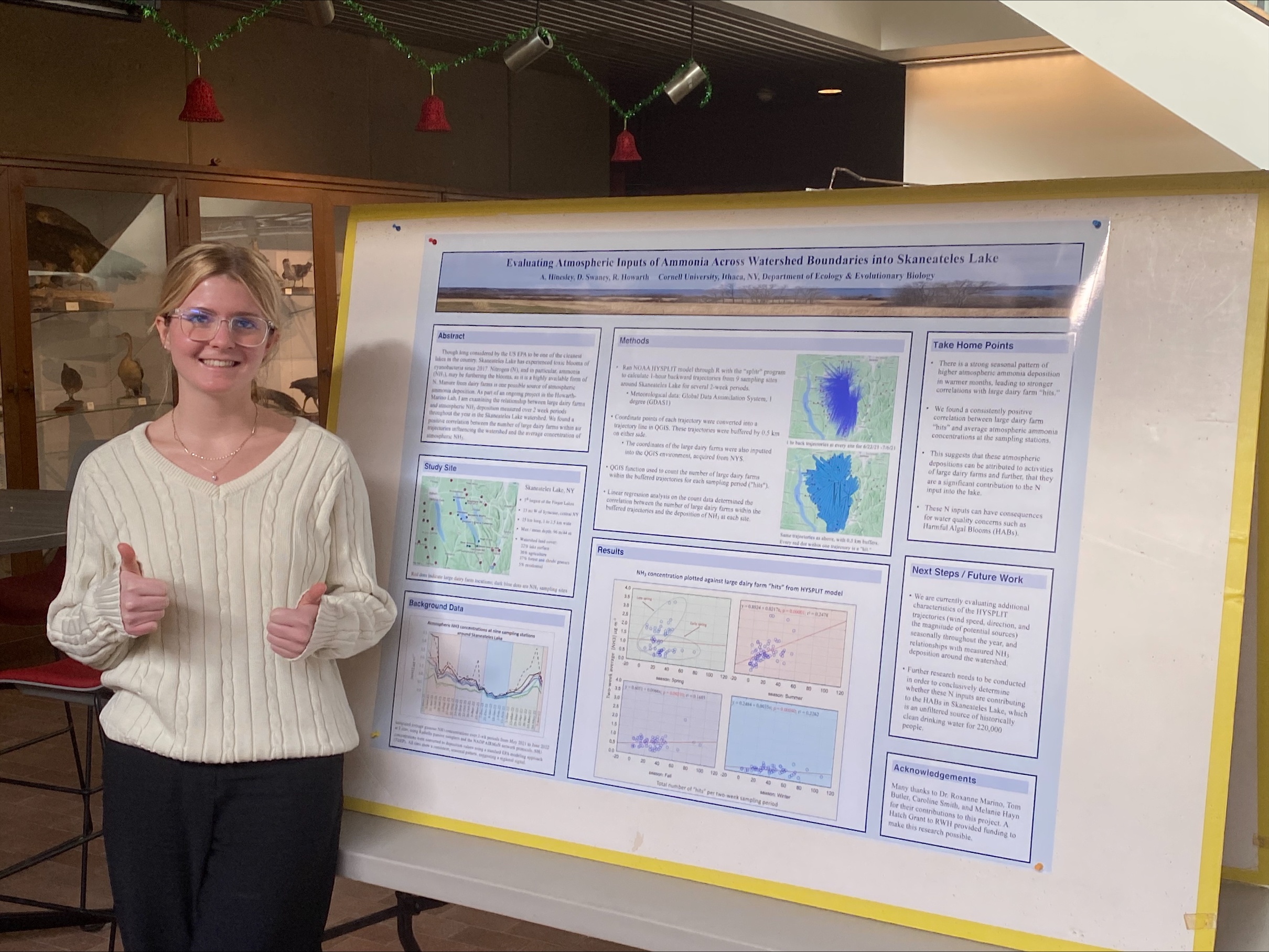 Amy Hinesley stands with her EEB presentation poster